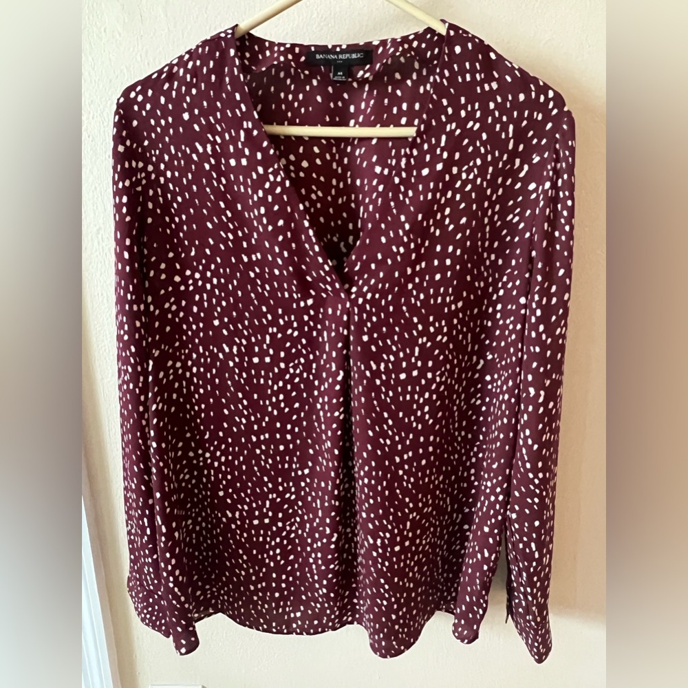 Long sleeve blouse with v neck front pleat.